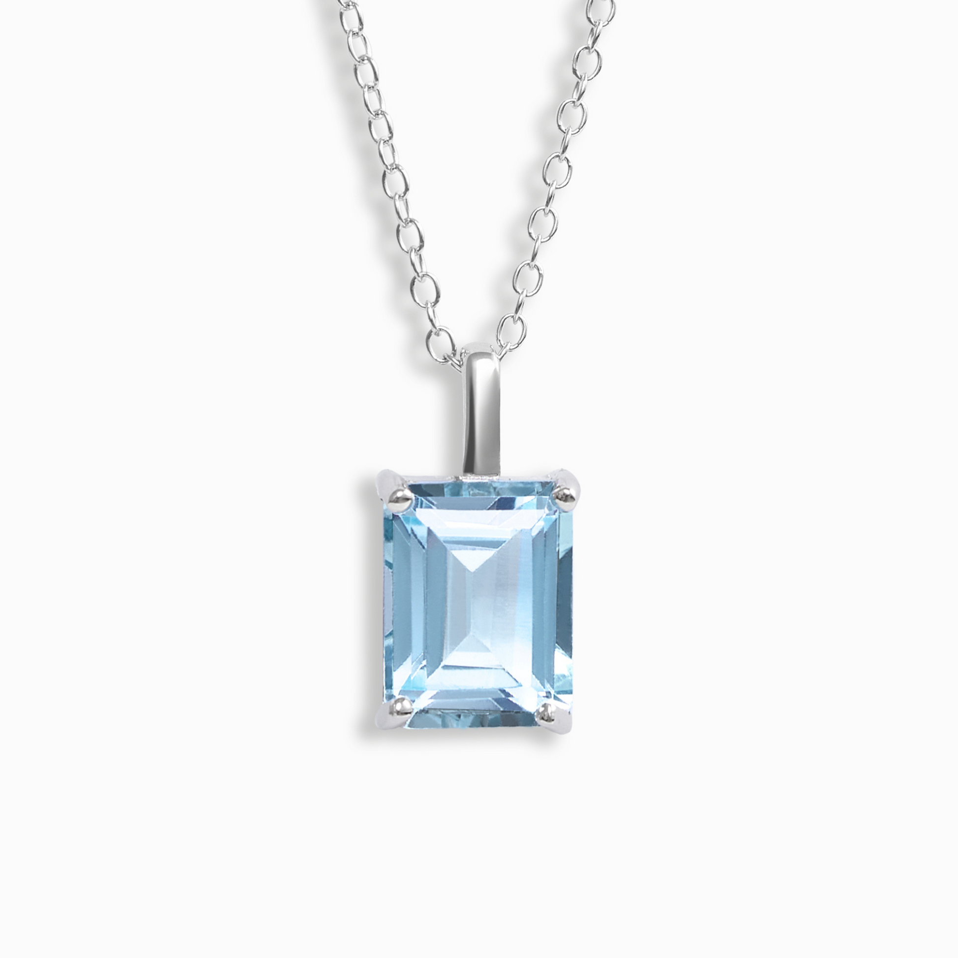 Silver necklace with a blue topaz gemstone pendant on a white background