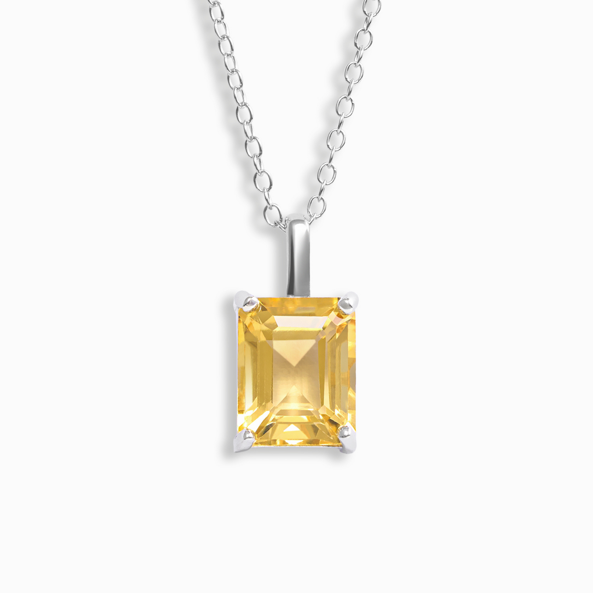 Yellow citrine gemstone pendant on a silver chain against a white background