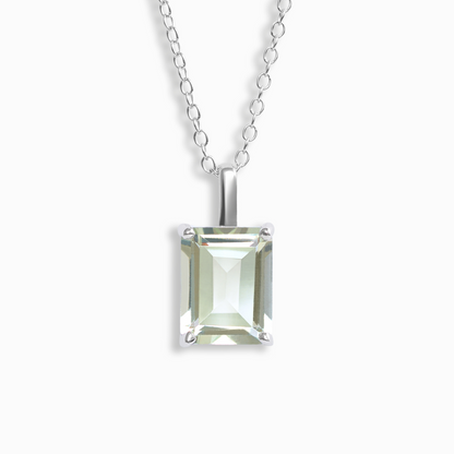 Silver necklace with a square-cut green amethyst gemstone pendant on a white background