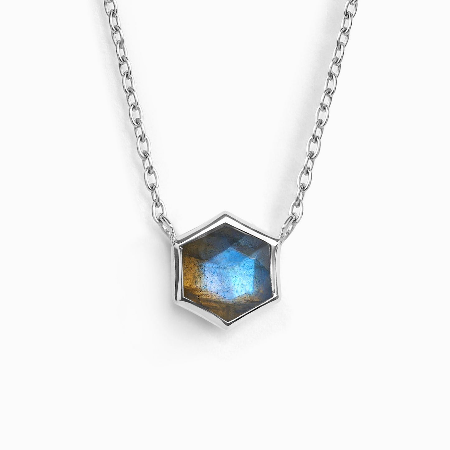 Hexagonal labradorite gemstone pendant on a silver chain against a white background