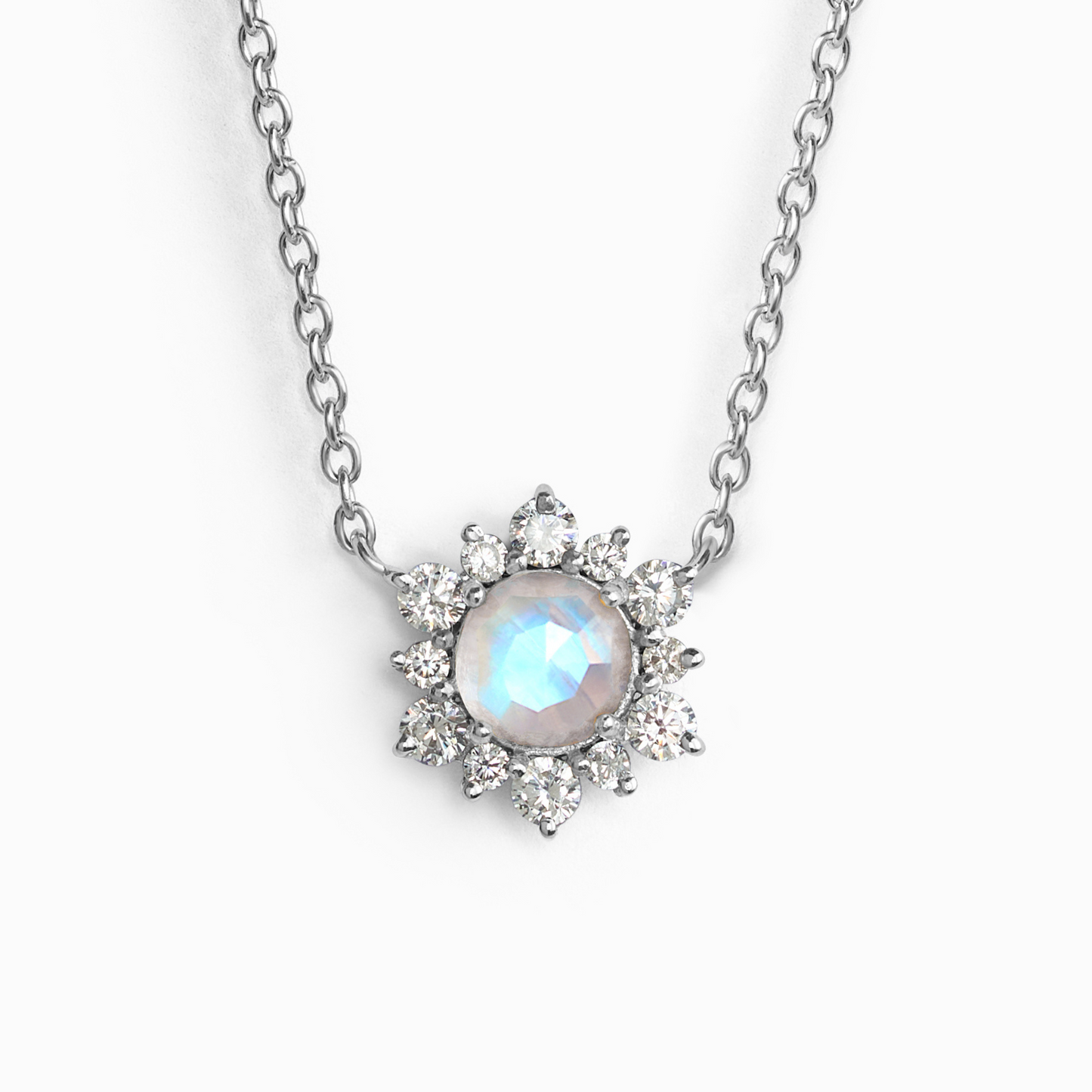 Silver necklace with a moonstone gemstone and star-shaped pendant on a white background