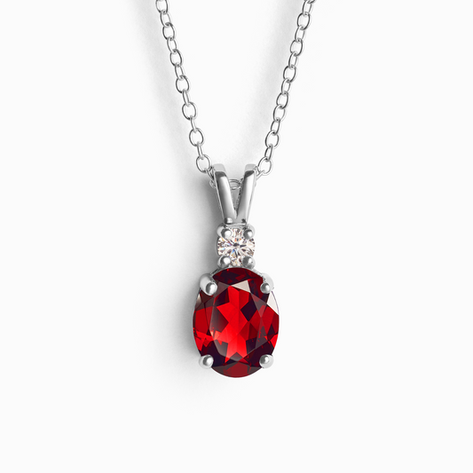 Red garnet gemstone necklace with silver chain on a white background