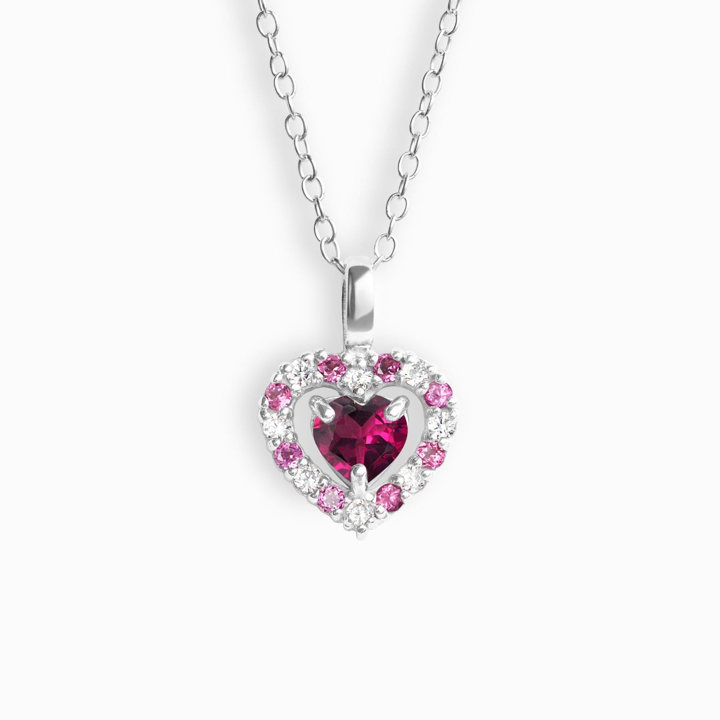 Heart-shaped pendant with pink garnet gemstones on a white background