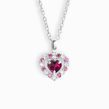 Heart-shaped pendant with pink garnet gemstones on a white background