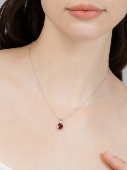Necklace with a red garnet gemstone pendant on a ladies's neck