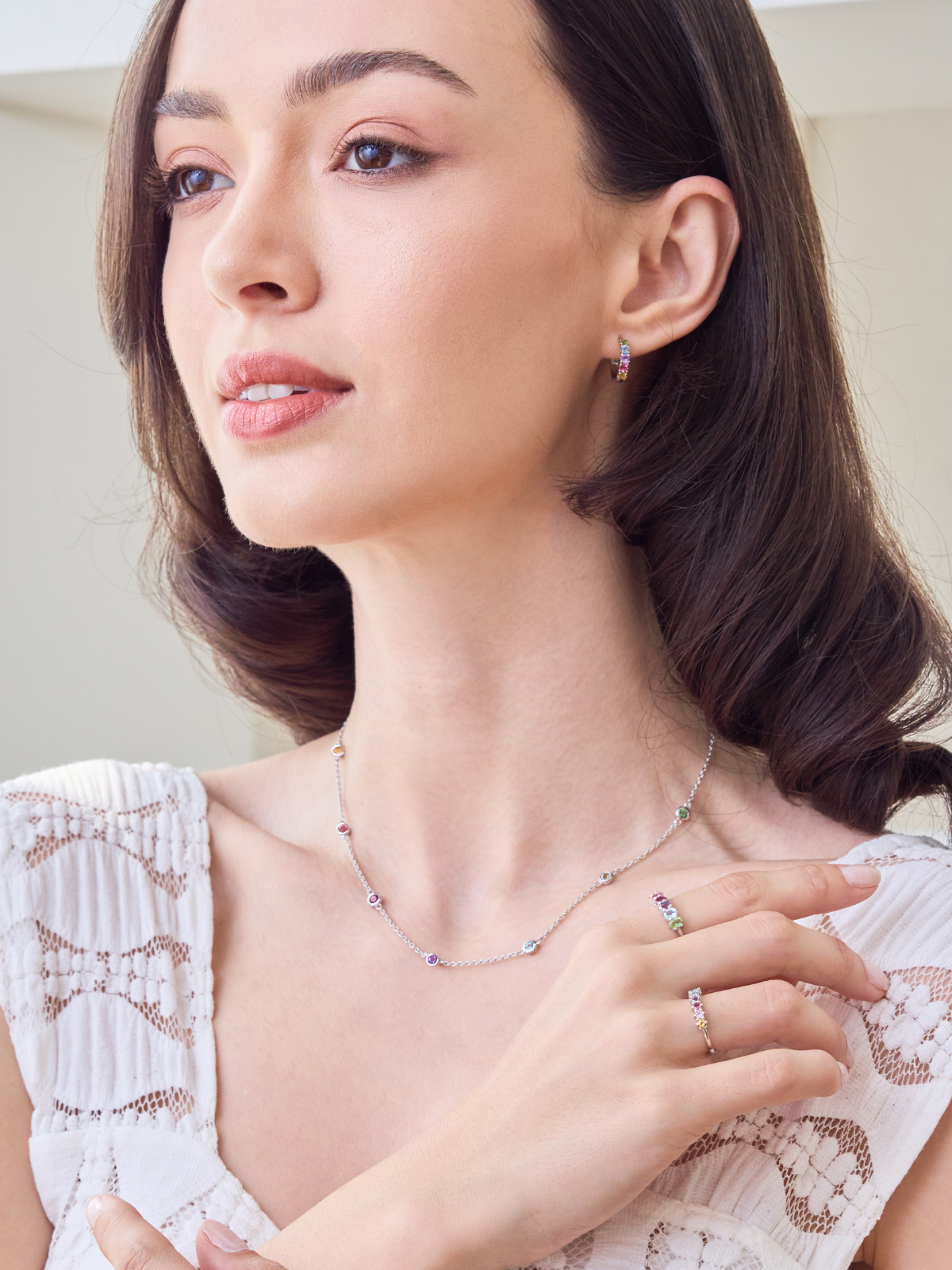 Woman wearing a necklace and ring, close-up of jewelry