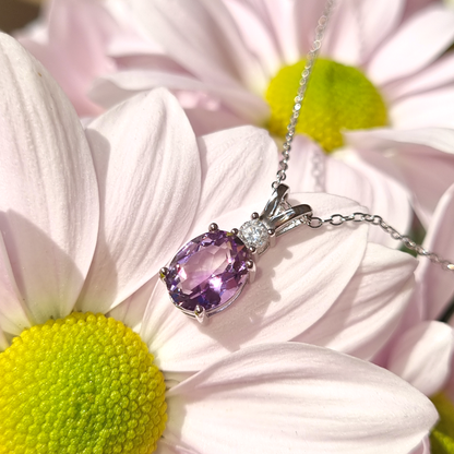 Amethyst pendant silver necklace on a floral background