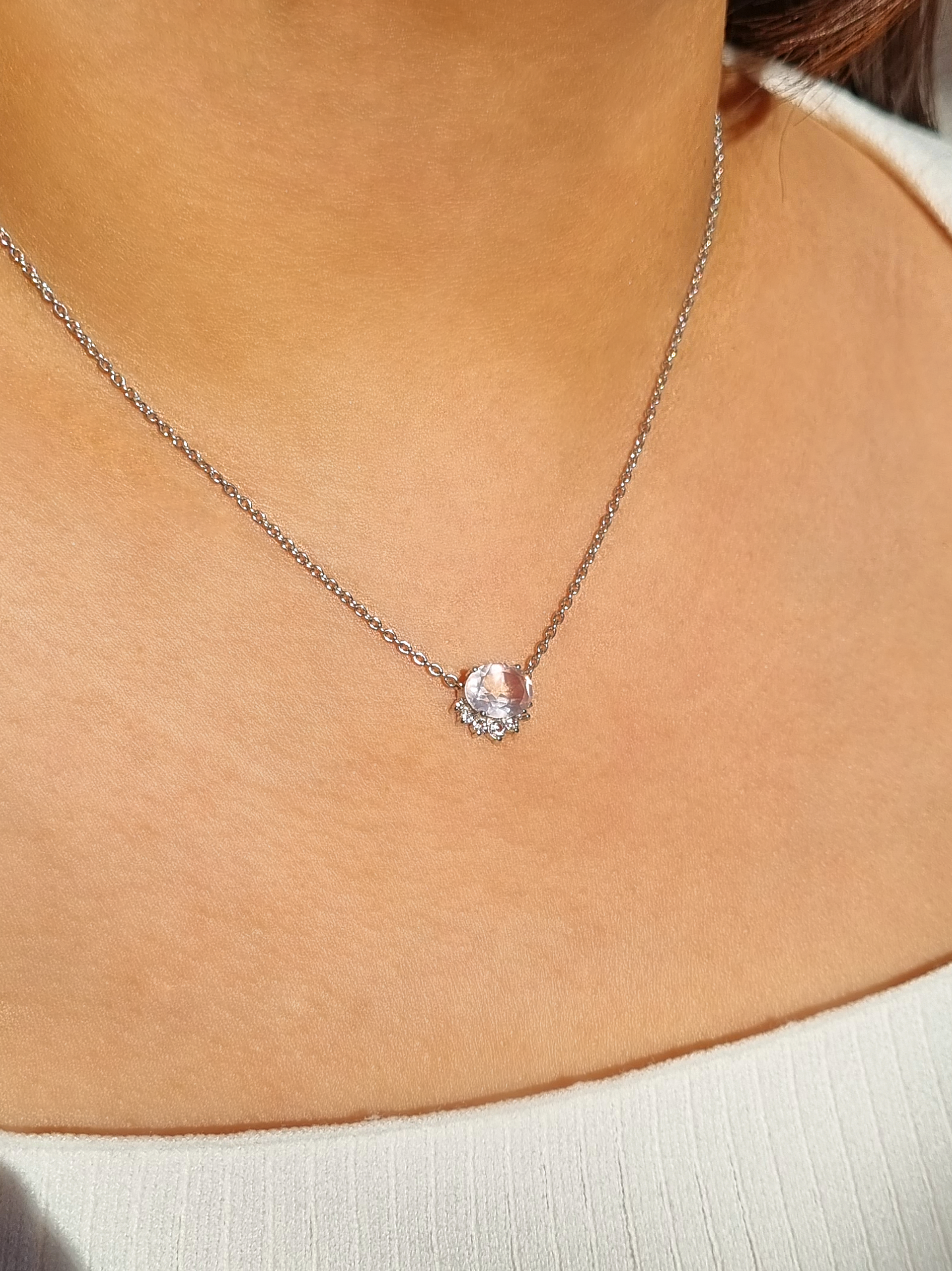 Necklace with a rose quartz gemstone worn by a lady