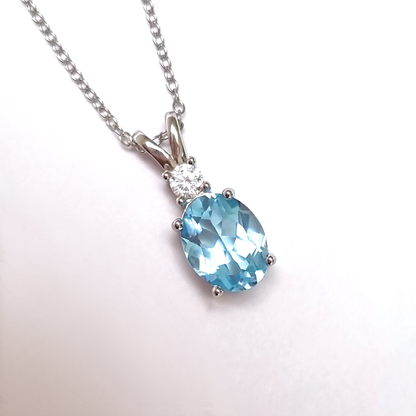 Necklace with a blue topaz gemstone pendant on a white background