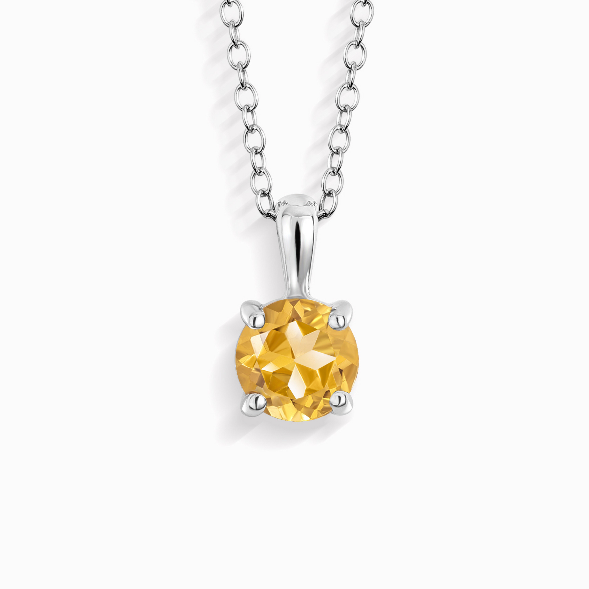 Yellow citrine gemstone pendant on a silver chain against a white background
