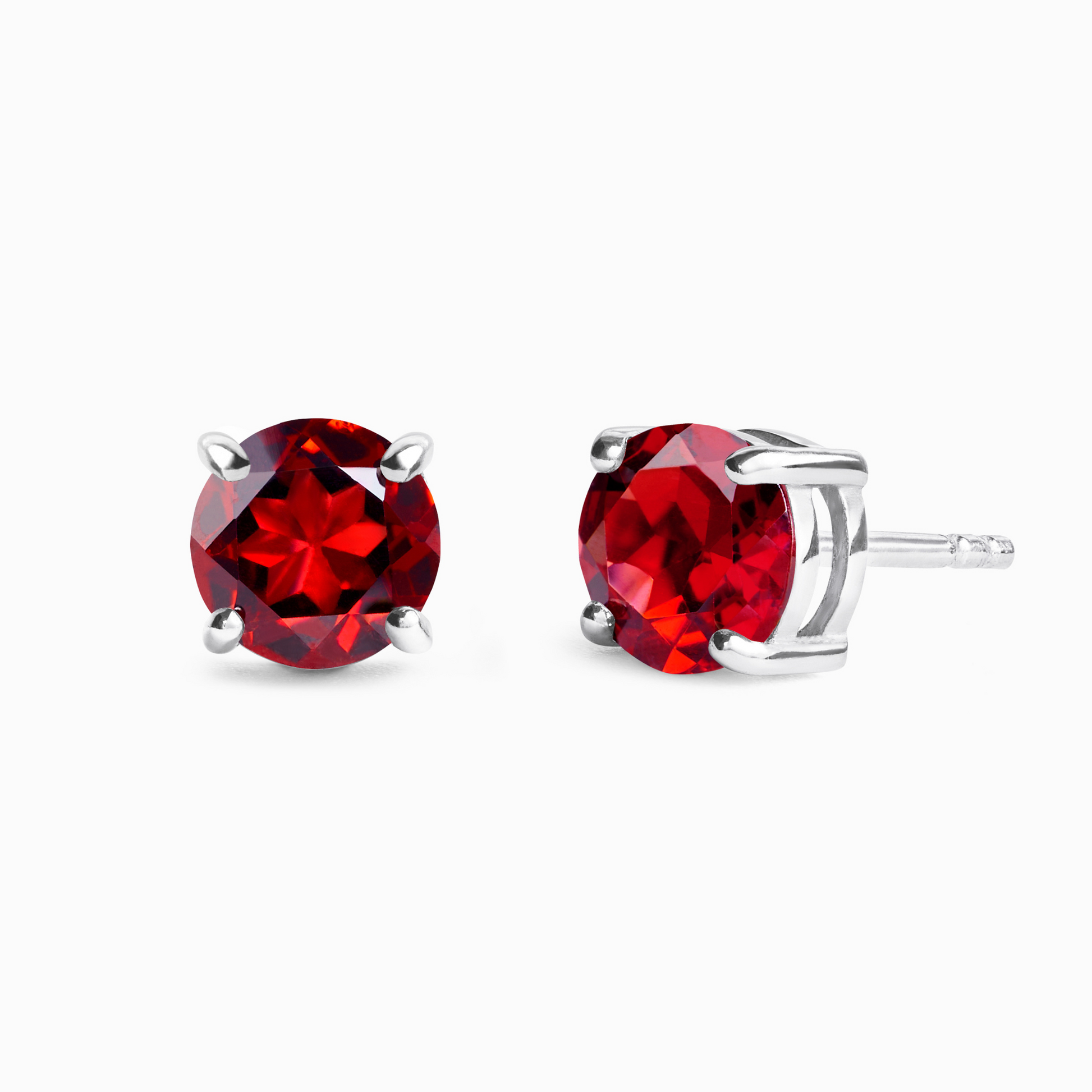 Red garnet gemstone stud earrings on a white background