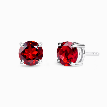 Red garnet gemstone stud earrings on a white background