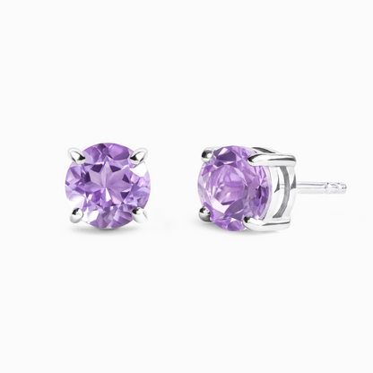 Pair of purple amethyst stud earrings on a white background