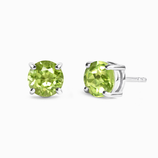 Pair of green peridot gemstone stud earrings on a white background
