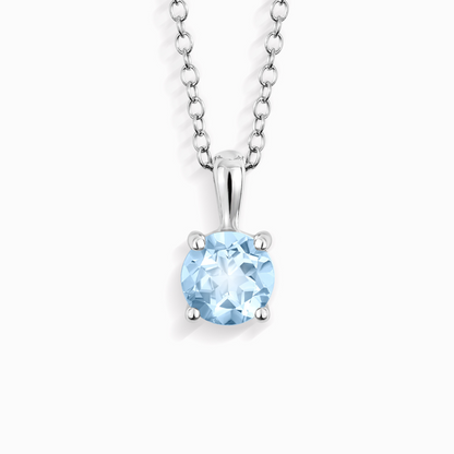 Silver necklace with a blue topaz gemstone pendant on a white background