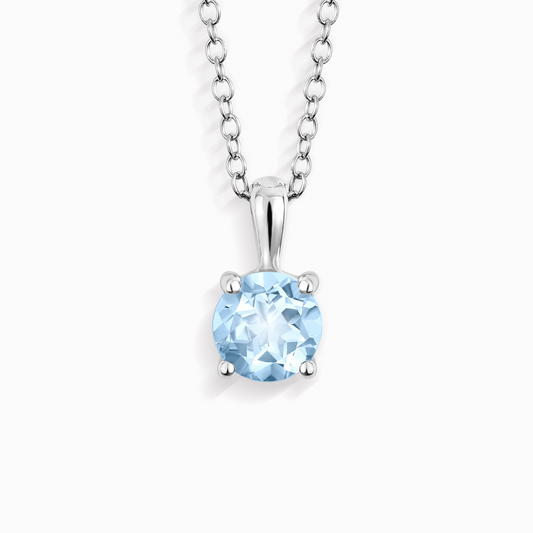Silver necklace with a blue topaz gemstone pendant on a white background