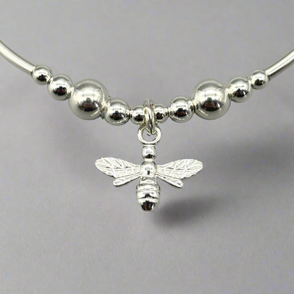 Closeup of bee charm sterling silver stacking stretch bracelet for her by My Silver Wish