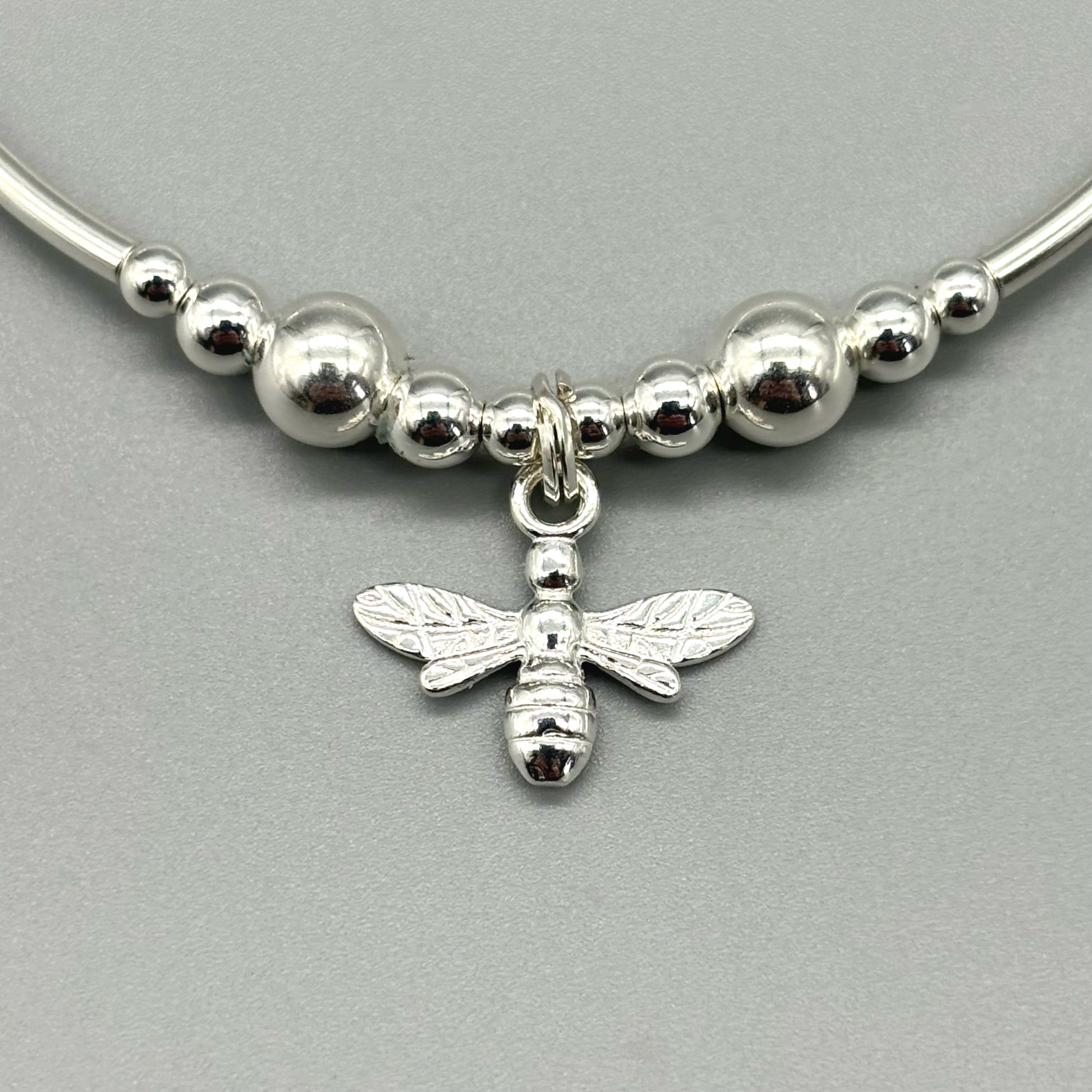 Closeup of bee charm sterling silver stacking bracelet by My Silver Wish