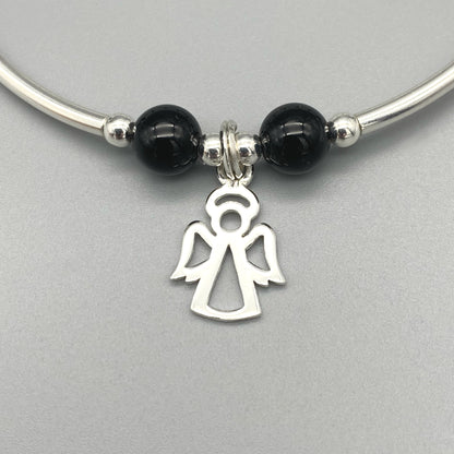Closeup of Angel charm black onyx gemstone women's sterling silver stacking bracelet by My Silver Wish