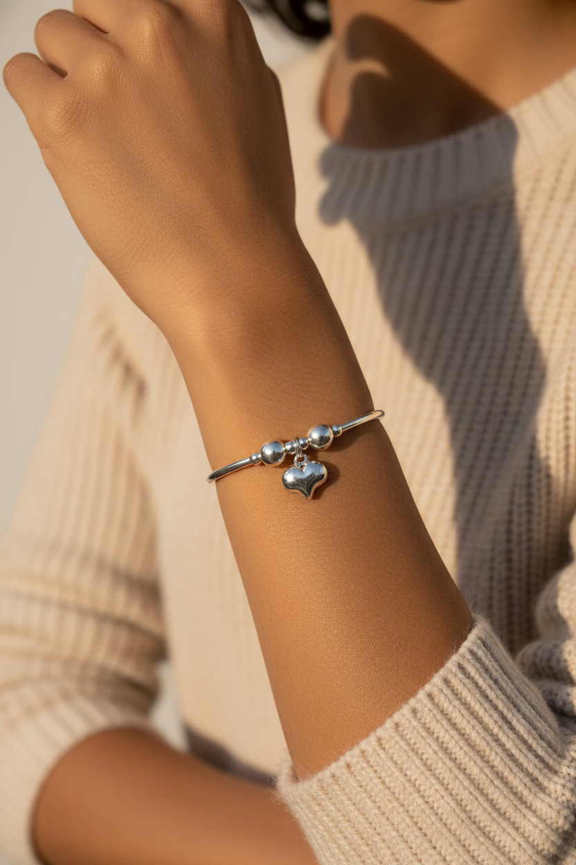 Woman wearing Puff Heart Charm Women's Sterling Silver Stacking Bracelet by My Silver Wish
