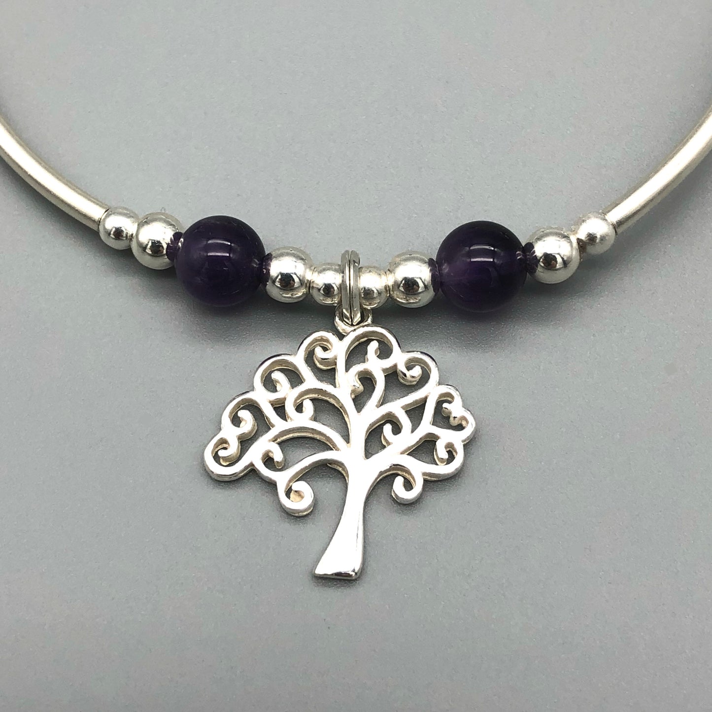 Closeup of Silver Tree Charm & Amethyst Healing Crystal Women's Stacking Bracelet