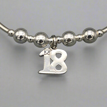 Close up of 18th Birthday charm girl's sterling silver stacking bracelet by My Silver Wish
