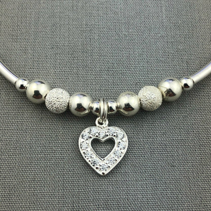 Closeup of Crystal heart charm sterling silver stacking charm bracelet by My Silver Wish
