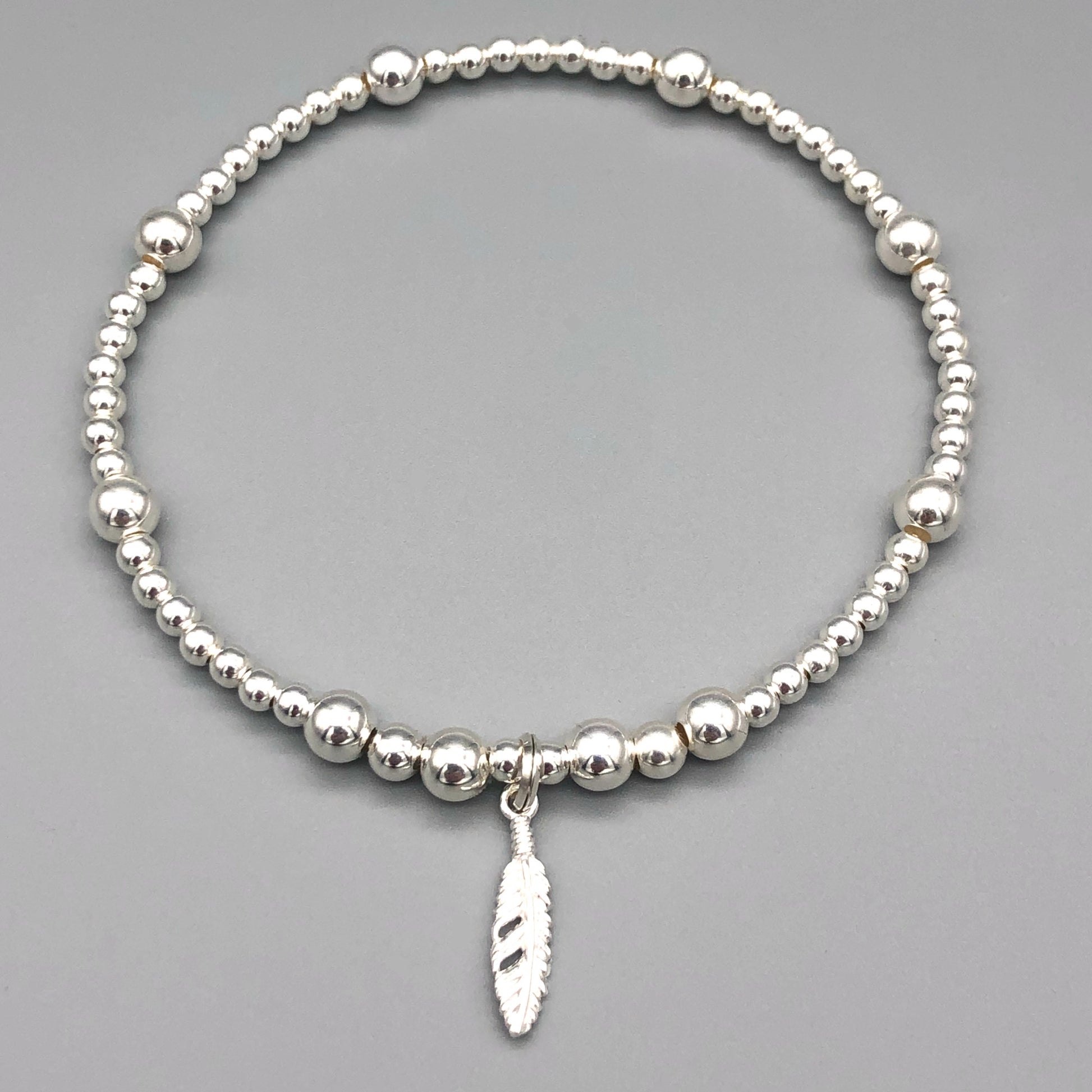 Feather charm sterling silver stacking charm bracelet by My Silver Wish