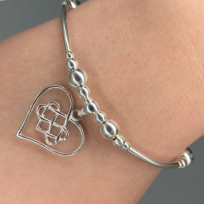 Closeup of Heart & Infinity symbol sterling silver stacking charm bracelet by My Silver Wish