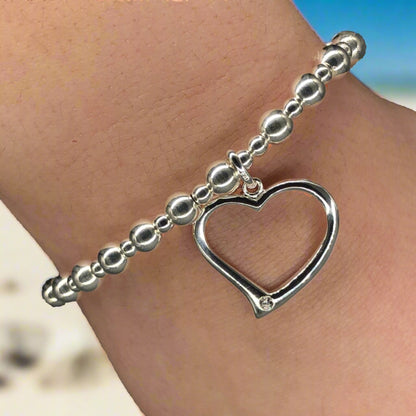 Closeup of Large open heart sterling silver stacking charm bracelet by My Silver Wish