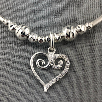 Closeup of Swirl heart charm sterling silver stacking charm bracelet by My Silver Wish