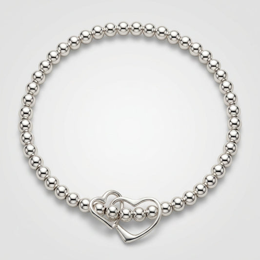 A sterling silver bracelet featuring a double interlinked open heart charm as the central element, with small silver beads on stretch elastic by My Silver Wish