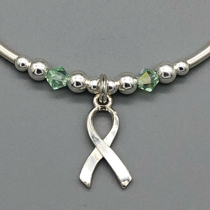 Closeup of Mental Health Awareness ribbon charm sterling silver hand-made women's stacking bracelet by My Silver Wish