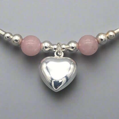 Closeup of Rose quartz solid heart charm sterling silver hand-made stacking bracelet for her by My Silver Wish